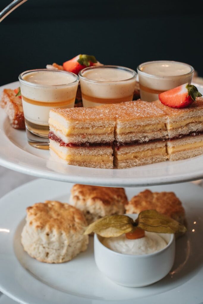 A delicious assortment of high tea desserts including cakes, biscuits, and panna cotta: a taste of Scottish indulgence.